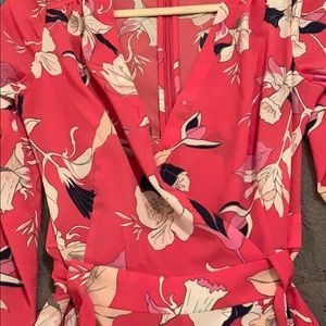 Multi color floral silk romper with waist tie.